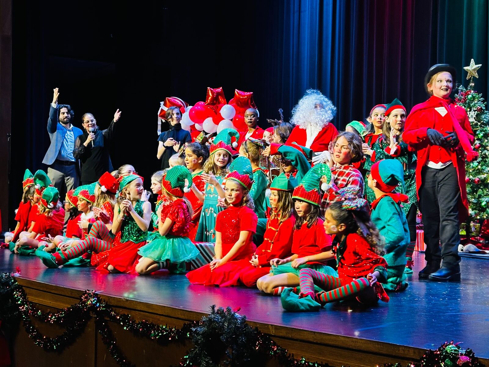 Young performers onstage in MTE's 2023 Christmas musical No One Wraps Like an Elf